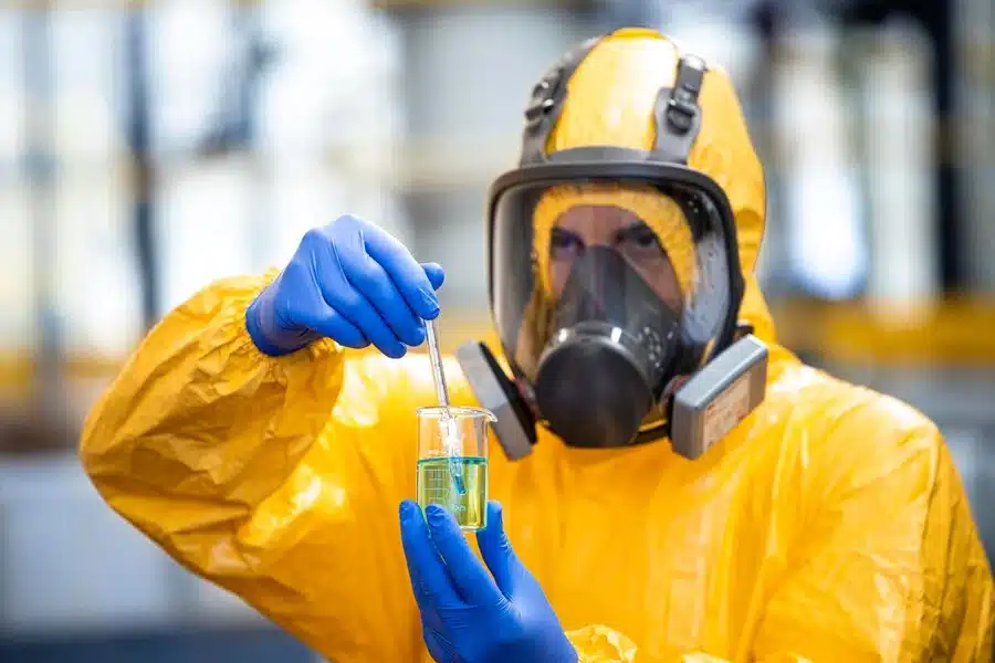 chemical worker with gas mask handling dangerous material