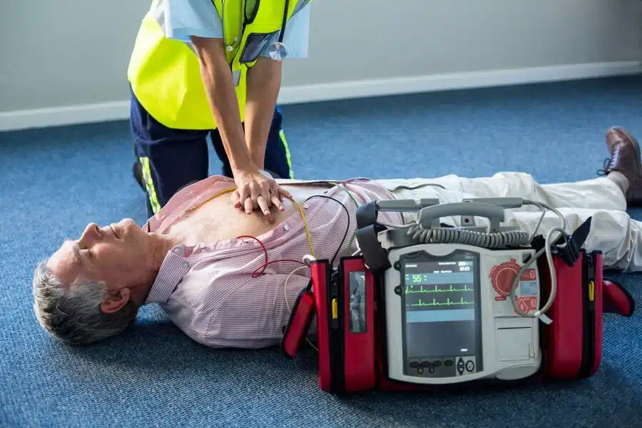 paramedic using external defibrillator
